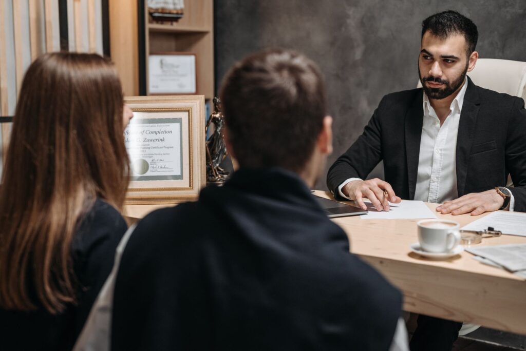 Lawyer meeting with clients at an office desk